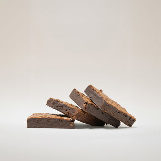 Stack of brownies on a light gray background