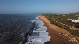 drone view of hive beach cliffs and sea
