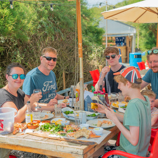 family eating outdoors at hive beach cafe